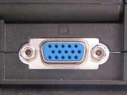 VGA port, trapezoidal border with 15 pins inside arranged in 3 staggered rows of 5, a nut on either side of the border